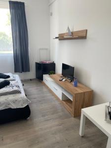 a room with a bed and a desk with a computer on it at Villa Gabino in Balatonberény +27 photos