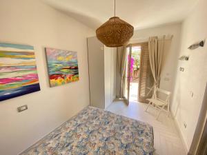 a living room with a painting on the wall at A Punta Tegge il mare la spiaggia il tramonto in La Maddalena