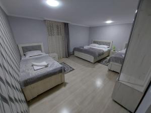 Habitación con 2 camas y espejo. en Hotel Rabat Castle en Akhaltsikhe
