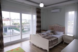 a bedroom with a bed and a large window at Amore Hotel Teki̇rova in Tekirova