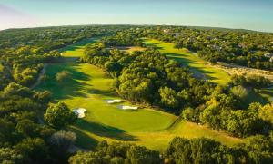 an aerial view of a golf course with several greens at Omni Barton Creek Resort and Spa Austin in Austin