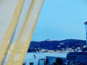 a view of a city from a window at BlueSky House in Skala
