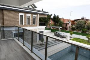 a balcony with a view of a house at Amore Hotel Teki̇rova in Tekirova