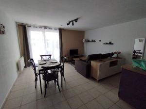 a living room with a table and a couch at Appartement 46 in Doussard