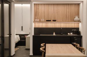 a kitchen with a table and a sink at Hygge Suites in Hersonissos