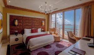 a bedroom with a large bed and a balcony at InterContinental Grand Ho Tram in Ho Tram