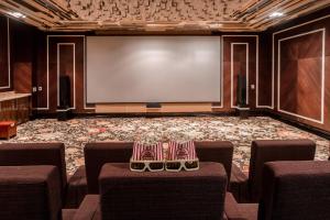a conference room with chairs and a projection screen at InterContinental Grand Ho Tram in Ho Tram