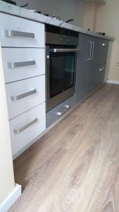 a kitchen with white cabinets and a stove top oven at Casa Dana in Sibiu