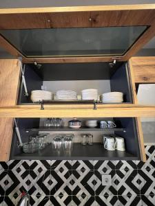 a shelf with plates and dishes in a kitchen at Fatih / Aksaray - Yusufpaşa in Istanbul