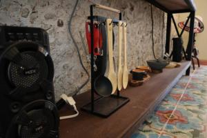 a wooden counter with cooking utensils hanging on a wall at Casa Coco in Mérida