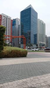 eine Stadtstraße mit hohen Gebäuden im Hintergrund in der Unterkunft Single Room Near "World Trade Centre&Beach" Abudhabi in Abu Dhabi