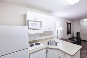 a kitchen with a sink and a microwave at Homestyle Studio Suites in Annapolis