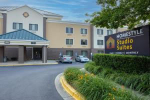 a hotel with cars parked in front of a building at Homestyle Studio Suites in Annapolis
