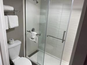 a bathroom with a glass shower with a toilet at Motel 6-San Diego, CA - Southbay in Chula Vista