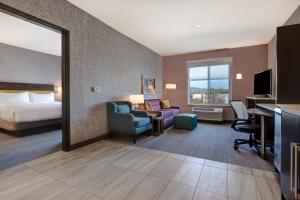 a hotel room with a bed and a desk at Home2 Suites By Hilton Petaluma in Petaluma