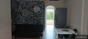 a room with a black curtain and a table and a window at olivegrove in Sidari