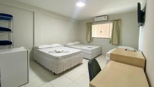 a hospital room with two beds and a window at CENTER PLAZA HOTEL in Cristalina