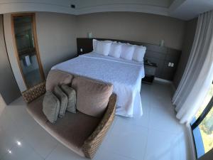 a bedroom with a large bed with towels on it at Tropical Executive Hotel in Manaus