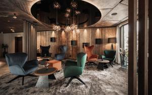 a lobby with chairs and tables and a chandelier at Hotel Wagnerhof in Pertisau