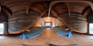 a room with two beds in a large wooden room at Hosteria La Luna in San Carlos de Bariloche