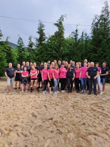 a group of people in pink shirts posing for a picture at Stara Kuźnia in Sosnówka