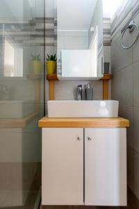 a bathroom with a white sink and a shower at sofia's apart 4u (114) in Glyfada +38 photos