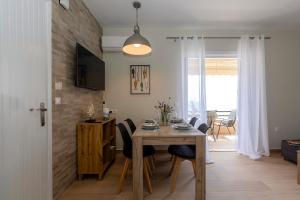 a dining room with a wooden table and chairs at sofia's apart 4u (114) in Glyfada