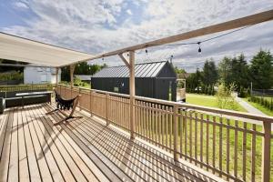 a deck with a bench and a tent on it at Wynki no. 69 in Łukta