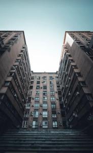 a tall building looking up into the sky at Apartament Ultracentral Universitate in Bucharest