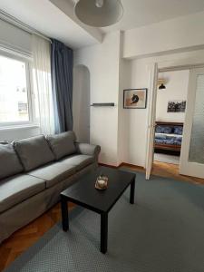a living room with a couch and a coffee table at Apartament Ultracentral Universitate in Bucharest