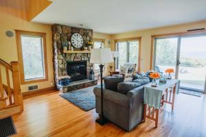 a living room with a couch and a fireplace at Charming Hammondsport Home with Lake Views and Pool! in Hammondsport