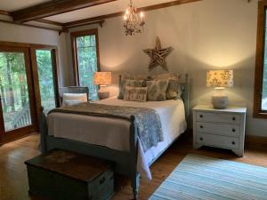 a bedroom with a bed and a chandelier at Beautiful Custom-built, Lodge-like Kerr Lake Home, non-smoking in Henderson