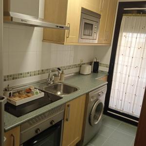 a kitchen with a sink and a dishwasher at Toledo Enamora Dos - PARKING INCLUIDO in Toledo