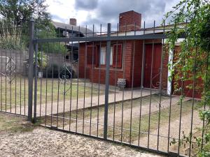 a fence in front of a house at Casa La Quinta in Villa Carlos Paz