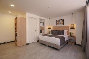 a bedroom with a large bed in a room at First Class Hotel in Medellín