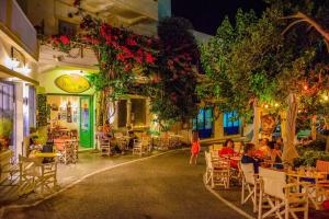 a group of people sitting at tables in a restaurant at Hytra view house in Kythira