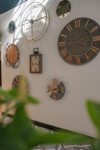 a bunch of clocks hanging on a wall at First Class Hotel in Medellín