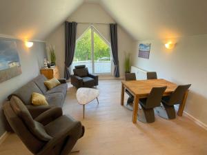 a living room with a couch and a table at Bernsteinfischer - Fewo mit 2 Balkone in Zempin
