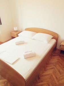 a large bed with two white pillows on it at APARTMANI JURIĆ in Trpanj
