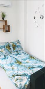 a bedroom with a bed with a blue and white blanket at Beautiful Sarandë in Sarandë