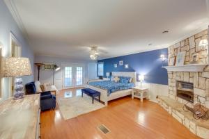 a bedroom with a bed and a fireplace at Dock, Deck and Kayaks Home on Cedar Creek Reservoir in Mabank +27 photos