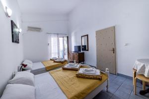 a living room with two beds and a couch at Apartments Vila Nikolić Rafailovići in Rafailovici