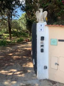 a building with a bird statue on the side of it at Casa Vacanze La Brii in Iglesias