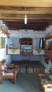 a room with two bunk beds and a bench at Tinas House in Afiartis