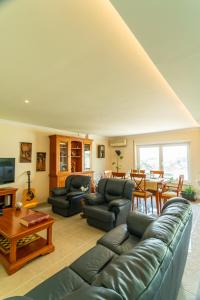 a living room with a couch and a table at Family Comfort House in Seixal