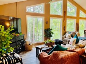 una sala de estar con muchas ventanas en Stunning Lake front home with stunning decor, en Mill Spring