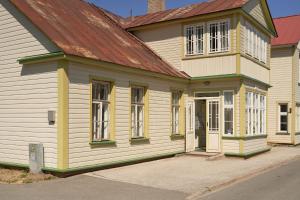 a yellow and white house with a red roof at Amalie Apartment in Haapsalu
