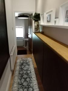 a kitchen with a counter and a rug on the floor at DERBY in Derby