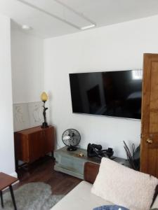 a living room with a large flat screen tv on the wall at DERBY in Derby