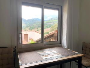a window in a room with a view of a mountain at Les Chênes-lièges d'Ambeille in Collioure +28 photos